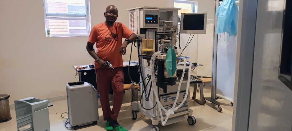 Engineers working on complex medical equipment